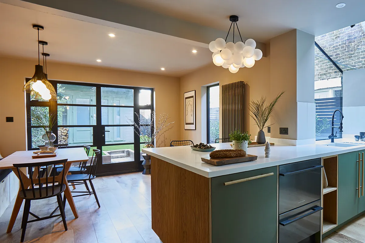 Open-plan living and dining with island counter and pendant lighting